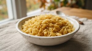 Golden sella basmati rice in a white bowl highlighting its characteristic parboiled golden color