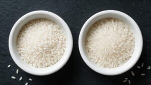 Two bowls of long-grain white rice comparing IRRI-9 and IRRI-6 varieties