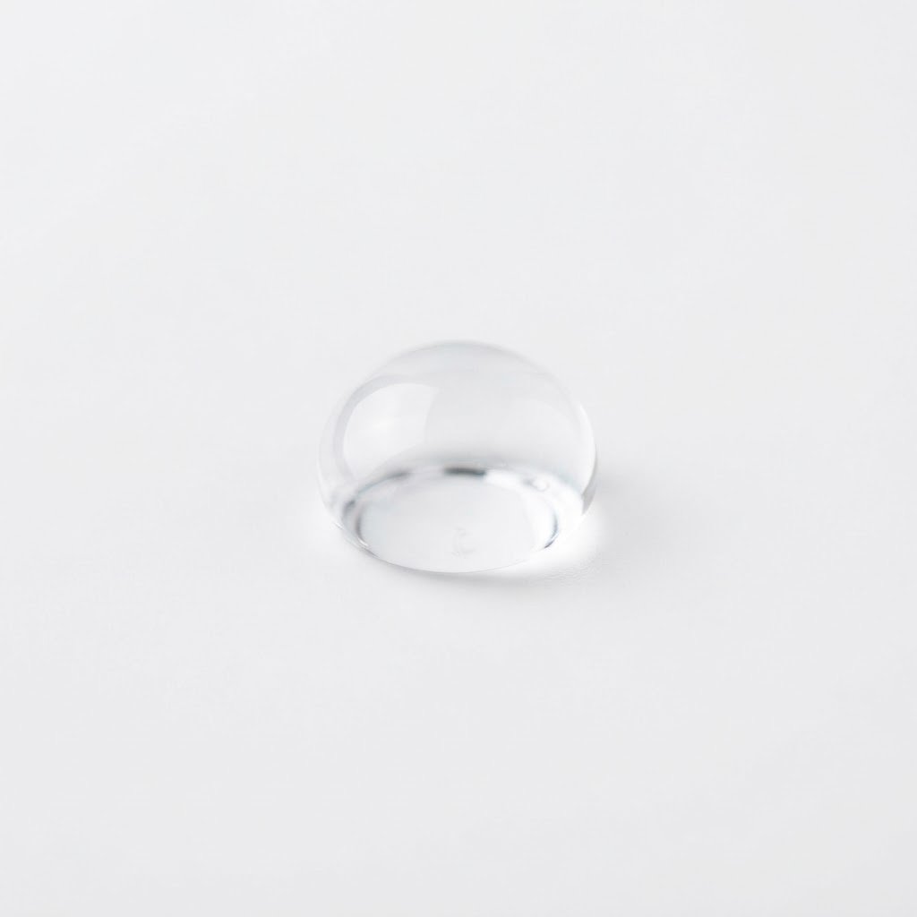A single water droplet representing the moisture limit on sella basmati rice