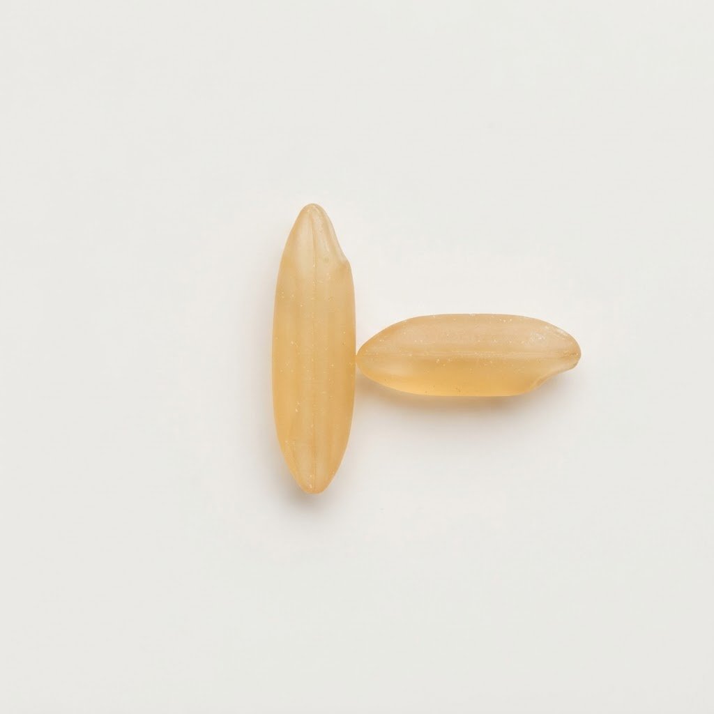 A long sella basmati grain beside a shorter grain showing the difference in length